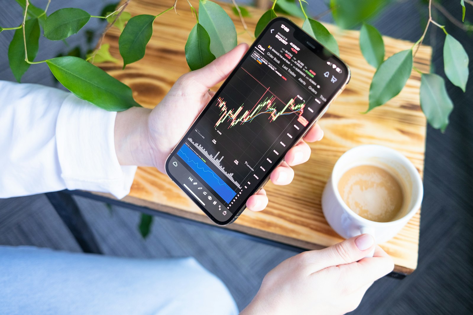 Crypto trader checking market charts on a smartphone