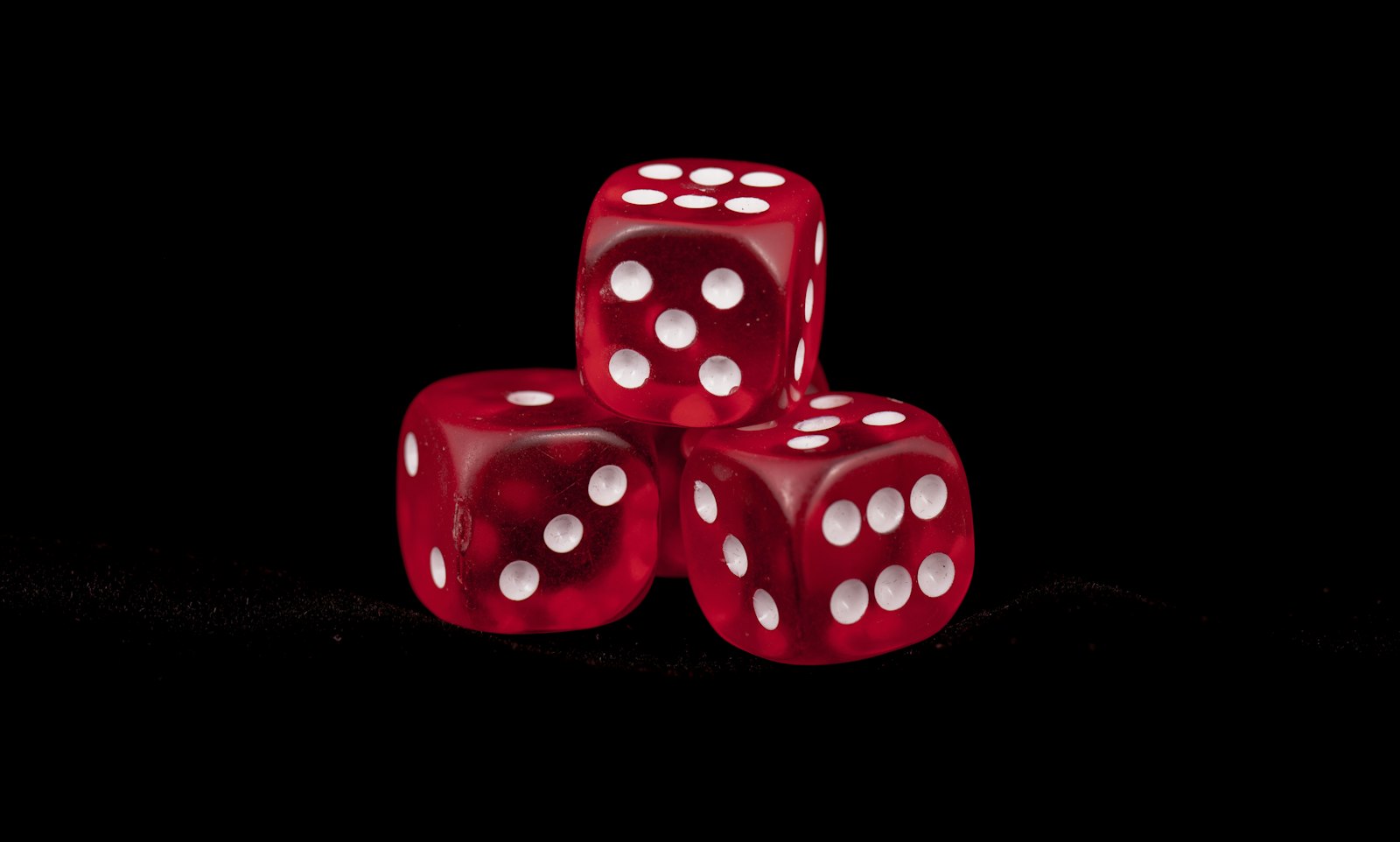 Dice and a calculator on a dark desk, representing probability and risk calculations